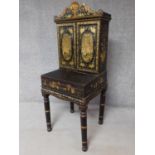 An antique gilt Chinoiserie lacquered Bureau de Dame with panel doors enclosing shelves and