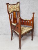 A 19th century Art Nouveau mahogany armchair with floral satinwood inlaid splat and fret cut