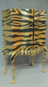 A mid 20th century drinks cabinet fitted revolving glazed interior with later painted tiger stripes.