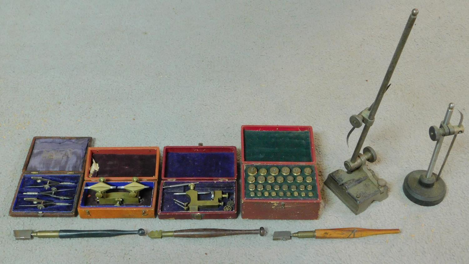 A collection of leather cased antique brass watch makers tools, clamps and engraving implements. J