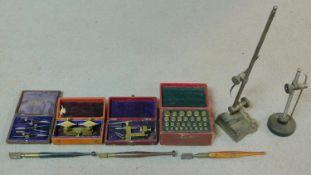 A collection of leather cased antique brass watch makers tools, clamps and engraving implements. J