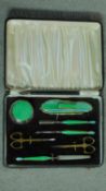 An Art Deco gilded brass green and blue engine turned enamel vanity set in a gilded blue leather