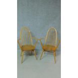 A pair of vintage beech framed Ercol Quaker Windsor armchairs with elm seats. H.96cm