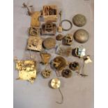 A collection of antique brass clock and watch mechnisms including strikers,bells, barrells and other