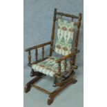 A 19th century American style turned beech child's rocking armchair. H.73cm