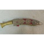 A vintage presentation Kukri knife in a pierced and engraved white metal scabbard decorated with a