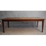 An antique style refectory dining table fitted with a frieze drawer to each end on square tapering