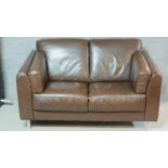 A contemporary two seater brown leather sofa. H.85 W.146 D.88cm