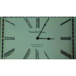 A rectangular battery powered polished stainless steel framed clock with cream face and black