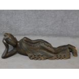 An early to mid 20th century Burmese carved hardwood reclining Buddha. With intricately carved