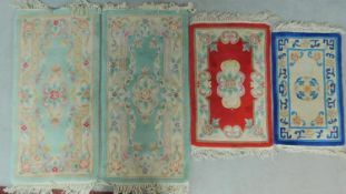 A miscellaneous collection of four small Chinese rugs. 61x140cm (largest)