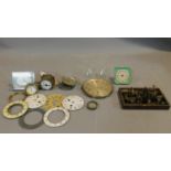 A collection of antique and vintage watch and clock parts and various tools. Including enamel
