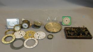 A collection of antique and vintage watch and clock parts and various tools. Including enamel
