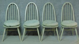 A set of four later painted vintage Ercol Windsor Quaker dining chairs with BS kitemark stamped to