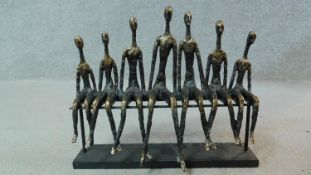 A moulded figure group, Giacometti style seated figures. H.35 W.39 D.13cm
