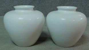 A pair of white glazed ceramic Portugese Alcobaca vases. Makers stamp to base. H.28cm