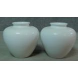 A pair of white glazed ceramic Portugese Alcobaca vases. Makers stamp to base. H.28cm