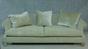 A contemporary scroll arm sofa in beige upholstery on block feet. H.67 W.220 D.100cm
