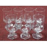 A set of seven Austrian mid century wine glasses with stylised floral design square stems with