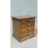 A small Victorian mahogany A. W. Gamage Ltd naturalist's chest of four graduating drawers on