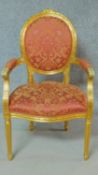 A gilt framed fauteuil in the Louis XVl style in floral rouge upholstery. H.104cm
