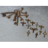 A collection of antique iron keys and various brass watch and clock keys. Largest 16.5cm.