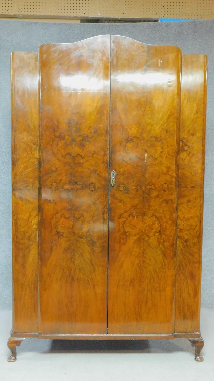 A mid 20th century Art Deco style figured walnut wardrobe on cabriole supports. H.196 W.125 D.55cm