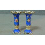 A pair of 19th century hand painted and gilded porcelain candle holders with floral design and