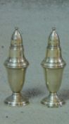 A pair of sterling silver salt and pepper shakers. H.13cm