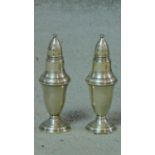 A pair of sterling silver salt and pepper shakers. H.13cm