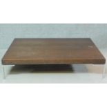 A B&B Italia low teak coffee table on metal supports. H.25 W.120 D.90cm