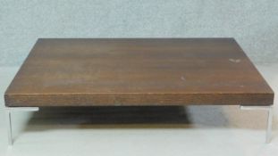 A B&B Italia low teak coffee table on metal supports. H.25 W.120 D.90cm