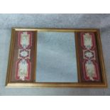 A gilt framed mirror with central plate flanked by stylised woollen tapestry panels. 69x49
