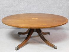 A Regency style mahogany, crossbanded and satinwood inlaid low coffee table on reeded quadruped