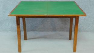 A mid 20th century teak foldover top card table with baize lining on square section supports. H.69
