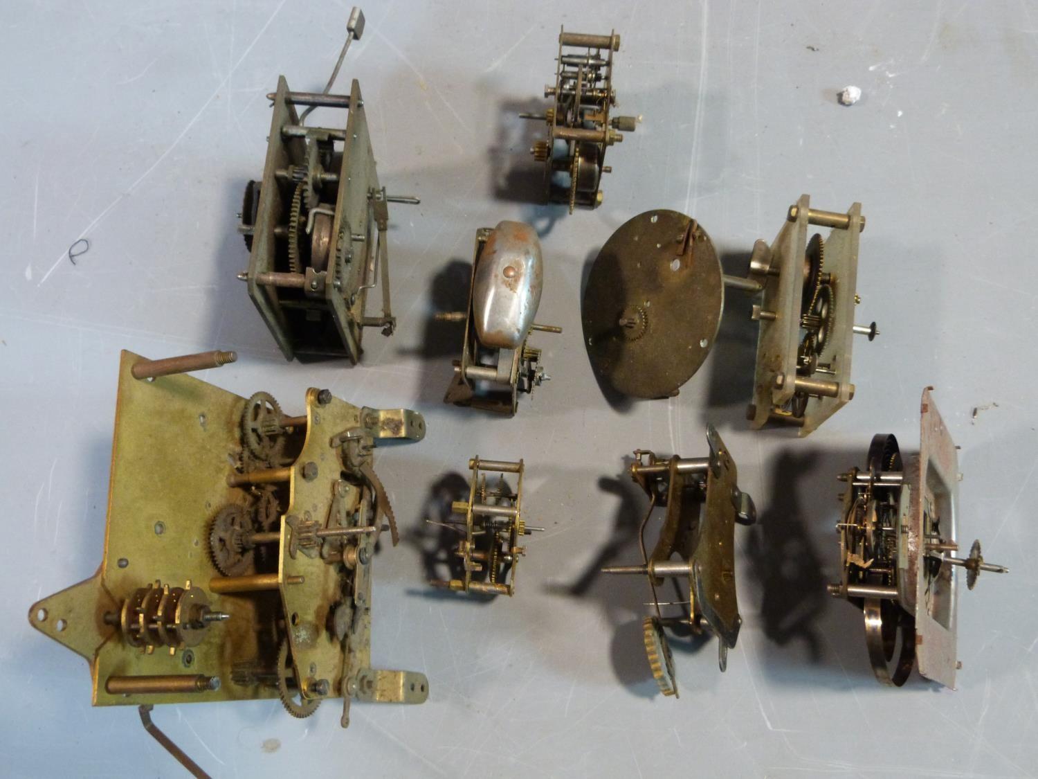 A collection of antique brass clock and watch mechnisms including strikers,bells, barrells and other - Image 7 of 14