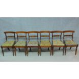 A set of six George IV faux rosewood and satinwood inlaid bar back dining chairs with drop in