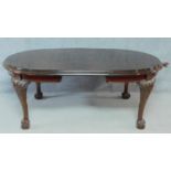 A late 19th century mahogany extending dining table on cabriole supports terminating in ball and
