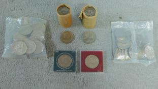 A collection of coins including two rolls of uncirculated crowns, commemorating Queen Elizabeth