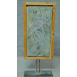 A framed slate and mixed media plaque on metal stand, abstract composition. H.84 W.34 D.15cm