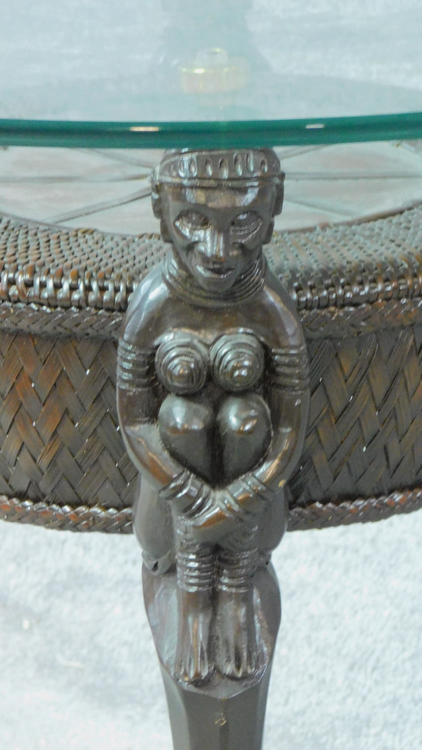 An Anglo African rattan glass top coffee table on figural supports. H.68 L.72 W.72cm - Image 3 of 4