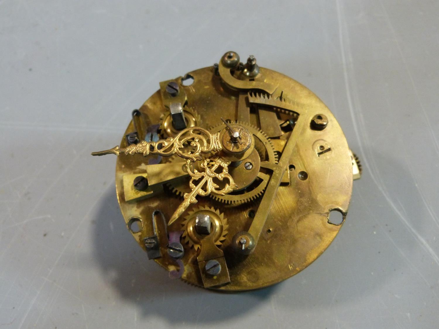 A collection of antique brass clock and watch mechnisms including strikers,bells, barrells and other - Image 8 of 14