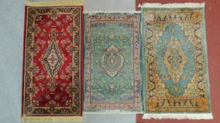 A miscellaneous collection of three patterned Eastern rugs.