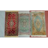 A miscellaneous collection of three patterned Eastern rugs.