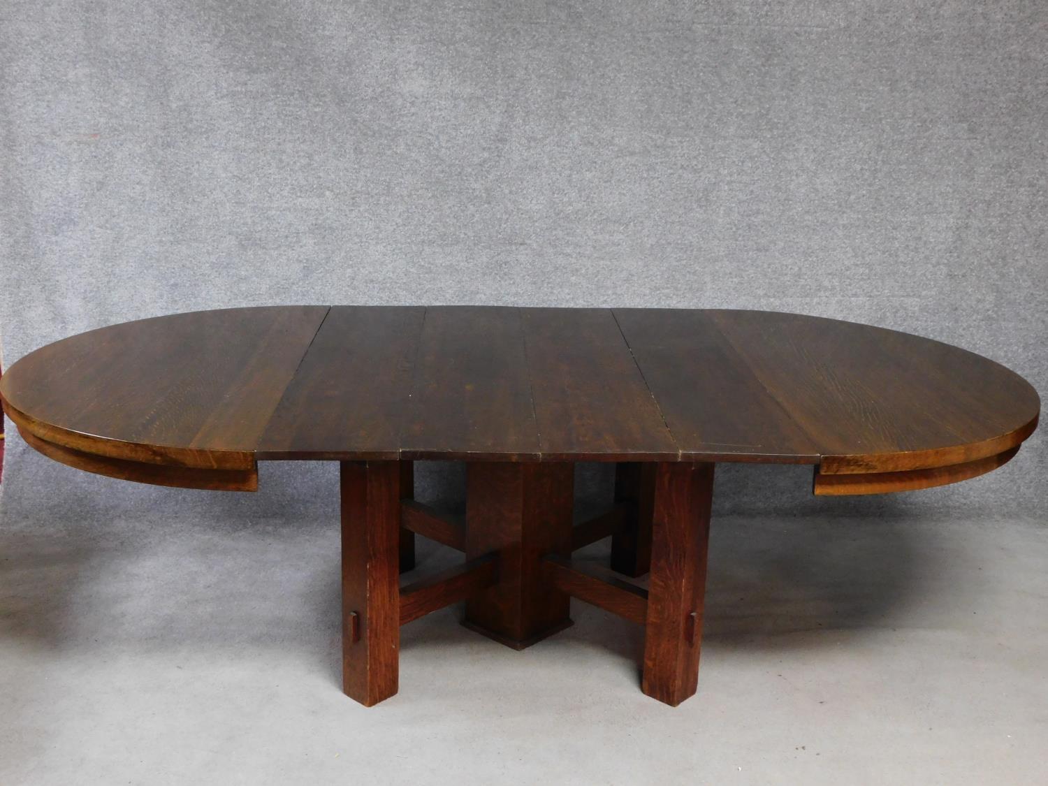 An American Arts and Crafts Mission style oak extending table with four extra leaves. H.72 W.249 D.