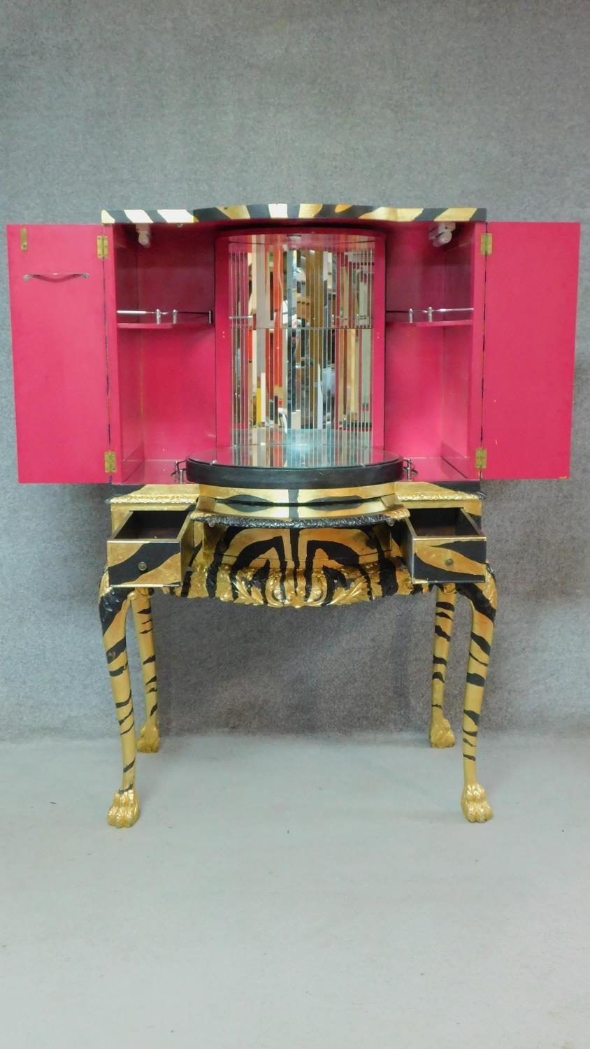 A mid 20th century drinks cabinet fitted revolving glazed interior with later painted tiger stripes. - Image 3 of 8