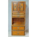 A Victorian elm and ebonised compactum wardrobe section with an arrangement of cupboards and