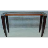 A large teak and metal bound console table with inset glass top. H.89 W.149 D.49cm