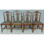 A set of four Georgian style mahogany dining chairs with leather drop in seats on square stretchered