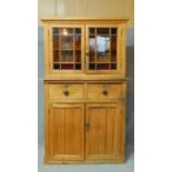 A Victorian pine dresser cabinet with coloured glass panelled top above cupboard section on plinth